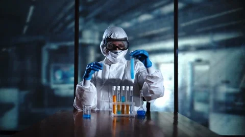 High Level Laboratory Scientist in a Coverall Conducting a Research Stock Footage 95342482