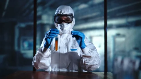 High Level Laboratory Scientist mixing chemical liquid in lab flask. Working in Stock Footage 95341338