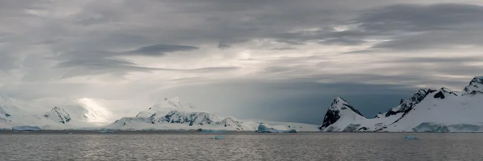 High level storm clouds over snow-capped mountains, Gerlache Strait, Antarctica Stock Photos