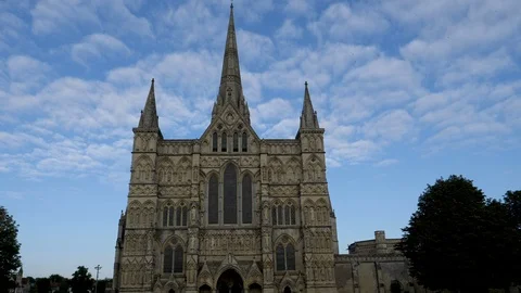 High light cloud drift slowly by spire of Salsbury Cathedral Stock Footage 95648975