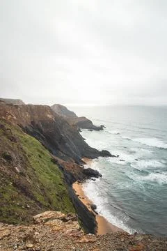 High limestone cliffs sinking into the Atlantic Ocean in the Algarve region,  Stock Photos