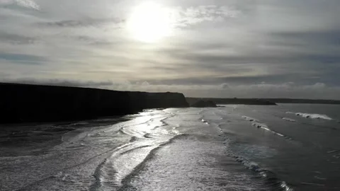 High to low angle moving shot over watergate bay in Cornwall, UK at Sunset Stock Footage 134403366