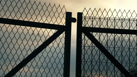 High metal gate security sunset background Stock Footage 284248401