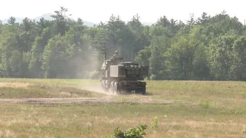 High mobility artillery rocket system HIMARS being driven over grass Vídeos de archivo 257553278