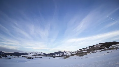 High morning clouds stream across the Elk Mountains Stock Footage 107640258