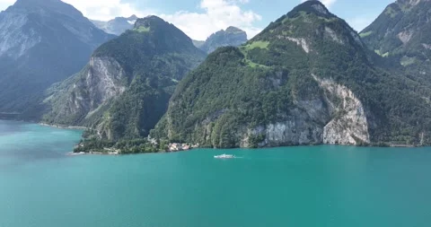 High mountain and lturqoise colored lake. Huge mountain alp. Boat and touristic Stock Footage 229461357