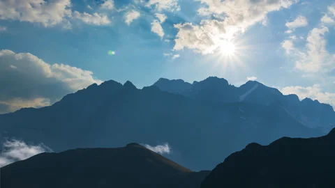 High mountain chain silhouette under a sparkle sun Stock Footage 248035442