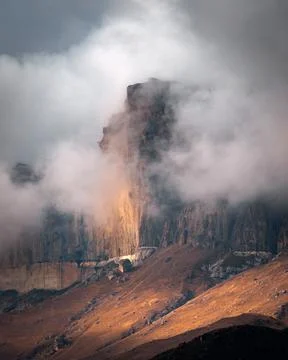 High mountain cliff with low clouds in Caucasus region in Russia Stock Photos