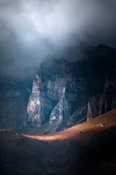High mountain cliff with low clouds in Caucasus region in Russia Stock Photos