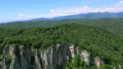 High mountain cliffs surrounded by forest Stock Footage 278227475