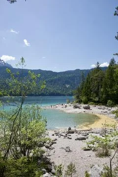 High Mountain Lake Surrounded by Forest and Hills 库存照片
