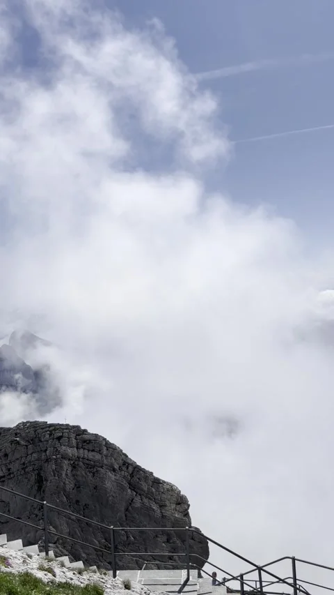 High mountain peaks covered in clouds dramatic landscape Stockbeeldmateriaal 334327428