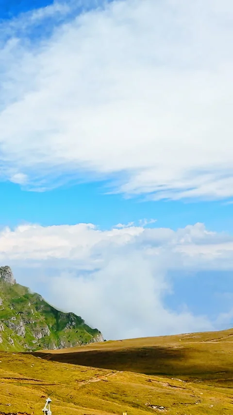 High mountain plateau with low clouds and rolling hills. Vertical video. Video stock 333147656