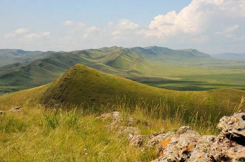A high mountain range with rocky formations running along the top in a pictur Stock Photos