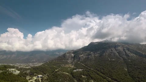 High mountain range surrounded by clouds under the bright blue sky Video stock 162120587