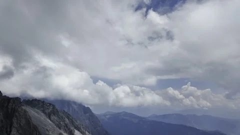 High Mountain Ridge with White Clouds and Distant Blue Peaks Stock Footage 340131337