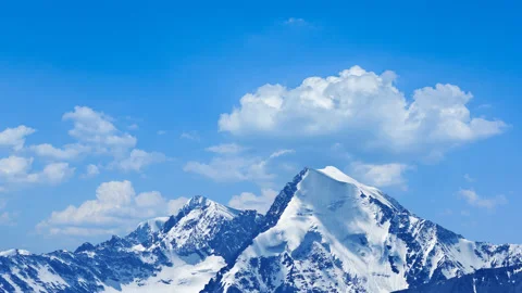 High mountain in snow in dense clouds time lapse scene Stock Footage 177348031