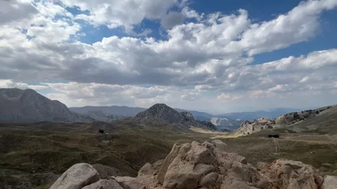 High Mountain View with Rocky Foreground and Dramatic Clouds Stock Footage 343830632