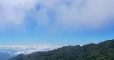 High Mountain Vista Over Cloud Covered Valleys And Cloud Passes Over Head Stock Footage 137515649