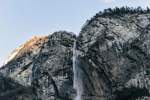 High mountain waterfall in the evening sun Stock Photos