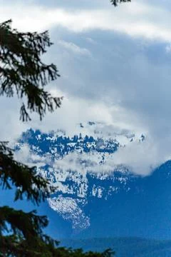 High mountains covered with dense forest, a lake in the distance. Montana, .. Stock Photos