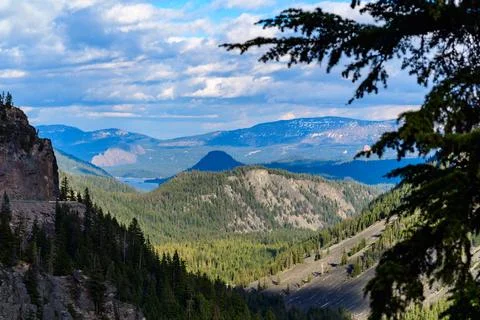 High mountains covered with dense forest, a lake in the distance. Montana, US 스톡 사진