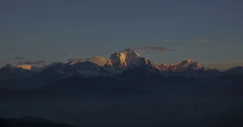 High mountains covered with snow become beige at sunrise Stock Footage 79605551