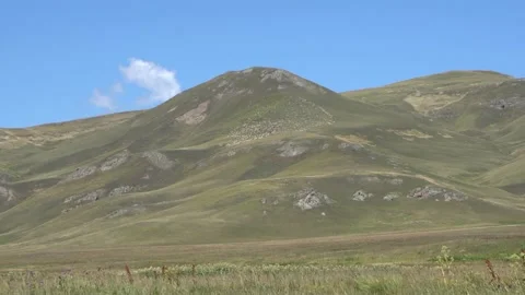 In the high mountains the wind blows the grass Stock Footage 137442843