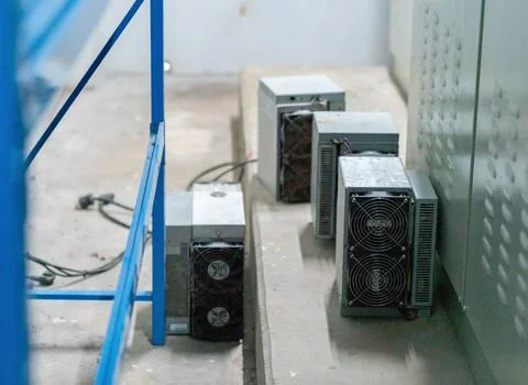 High-performance ASIC mining hardware modules with dual cooling fans placed.. Stock Photos