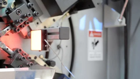 High-performance automatic machine for making steel springs. Linear panning from Stock Footage 76859680