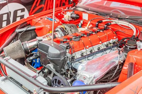 High-performance engine bay with red V8 showcasing precision engineering Stock Photos