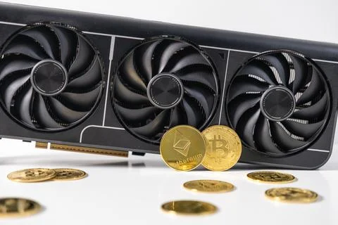 High-performance GPU with triple-fan cooling system next to Bitcoin and Eth.. Stock Photos