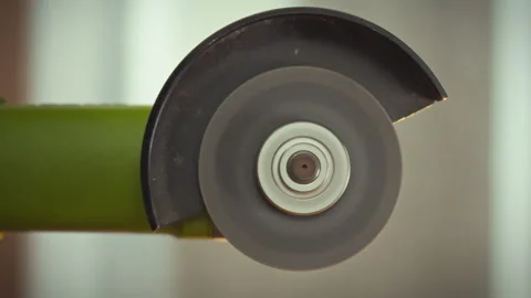 A high-performance industrial angle grinders cutting wheel rapidly spins sho Stock Footage 331313469
