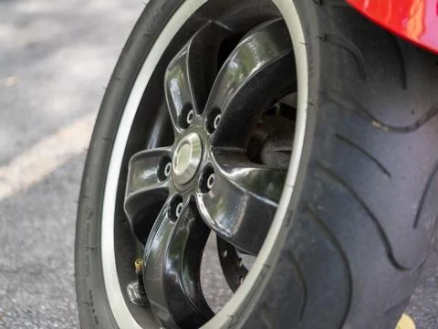 High-performance motorcycle tire close-up urban street detailed ground-leve.. Stock Photos
