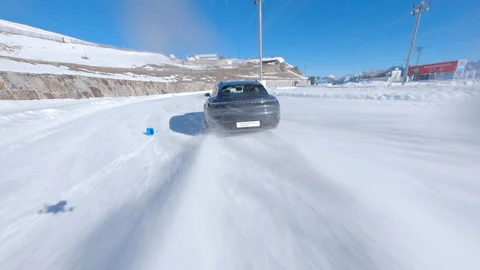 High-performance Porsche car testing on snow-covered circuit in Andorra, aerial Stock Footage 295251883