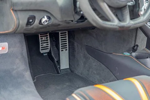 High-performance vehicle interior with dark textured floor and sporty pedals 写真素材
