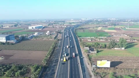High perspective cinematic aerial drone shot framing a long multi lane asphalt Video stock 337790048