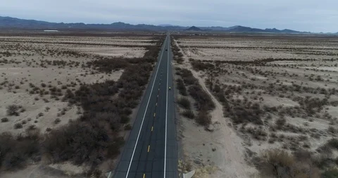 High perspective shows cyclist in huge desolate environment drone aerial 4K Stock Footage 111310696