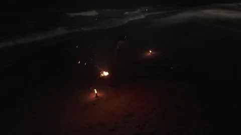 High Perspective of a Solo Fire Dancer Performing with a Staff and Burning Stock Footage 334333600