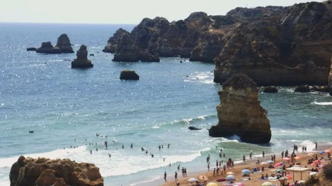 High perspective view of beachgoers at Cova Redonda Beach in Algarve, southern Stock Footage 115845546
