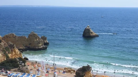 High perspective view of beachgoers at Cova Redonda Beach in Algarve, southern Stock Footage 115845822