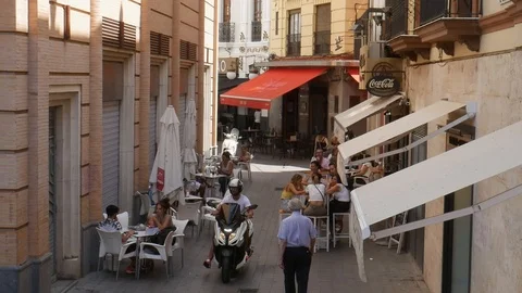 High perspective view of ordinary scene of cafe in Seville on a pedestrian Stock Footage 116084098