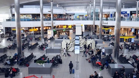 High perspective view of passengers and shops at departure terminal at Heathrow Stock Footage 102870190