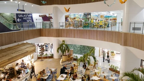 High perspective view of passengers at restaurant and duty free shops at Galeao Stock Footage 105509805