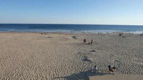 High perspective view of people at Carcavelos beach on a sunny day Stock Footage 130535666