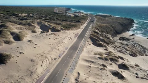 High perspective view of vehicles on the N247 hugging the coast of Guincho Stock Footage 245981639