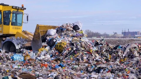 A high pile of trash moved by a landfill truck. Water, air contamination concept Stock Footage