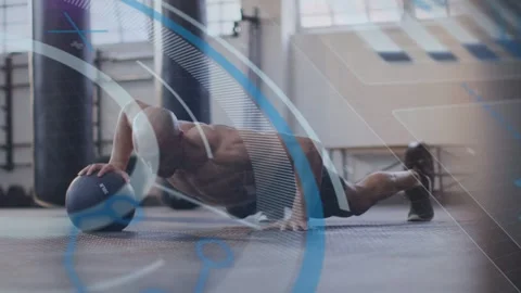 From high plank, man performing med-ball push-rolls to build core strength, blue Video stock 333145521