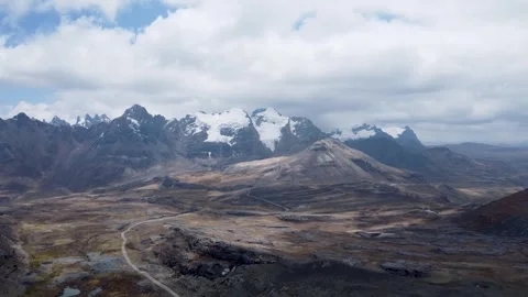 High POV camera moving over high plains with gravel road snaking into distance a Stock Footage 251761756