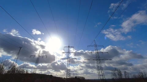 A high power line and a wind turbine as a time lapse video Stock Footage 264675895